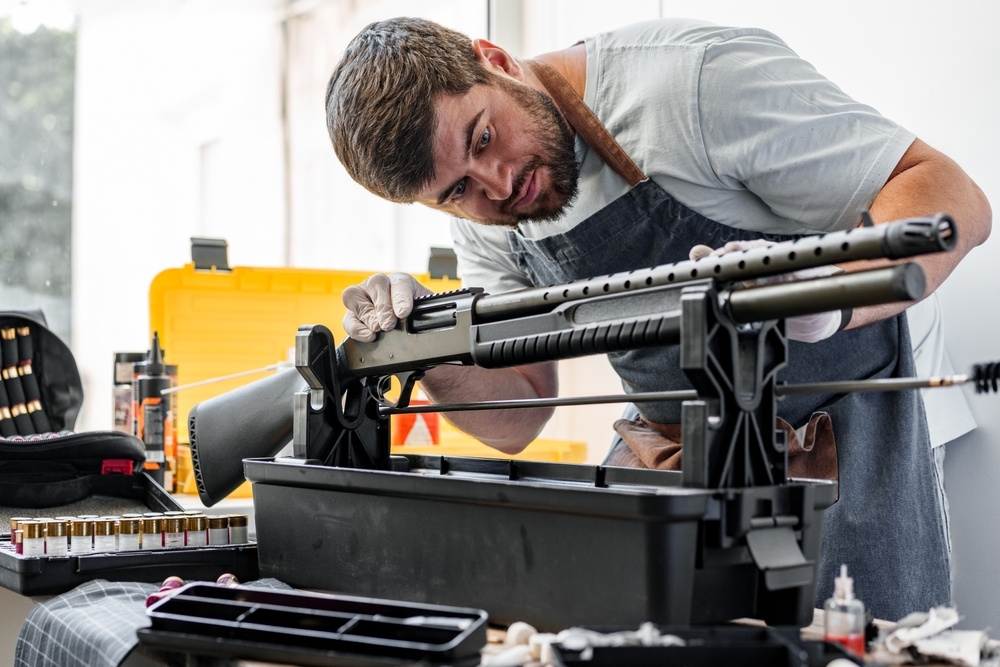 Gunsmith inspecting Pump Shotgun