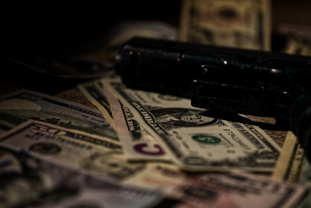 Handgun Laying on Money