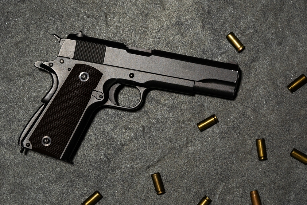1911 Fiream with scattered casings