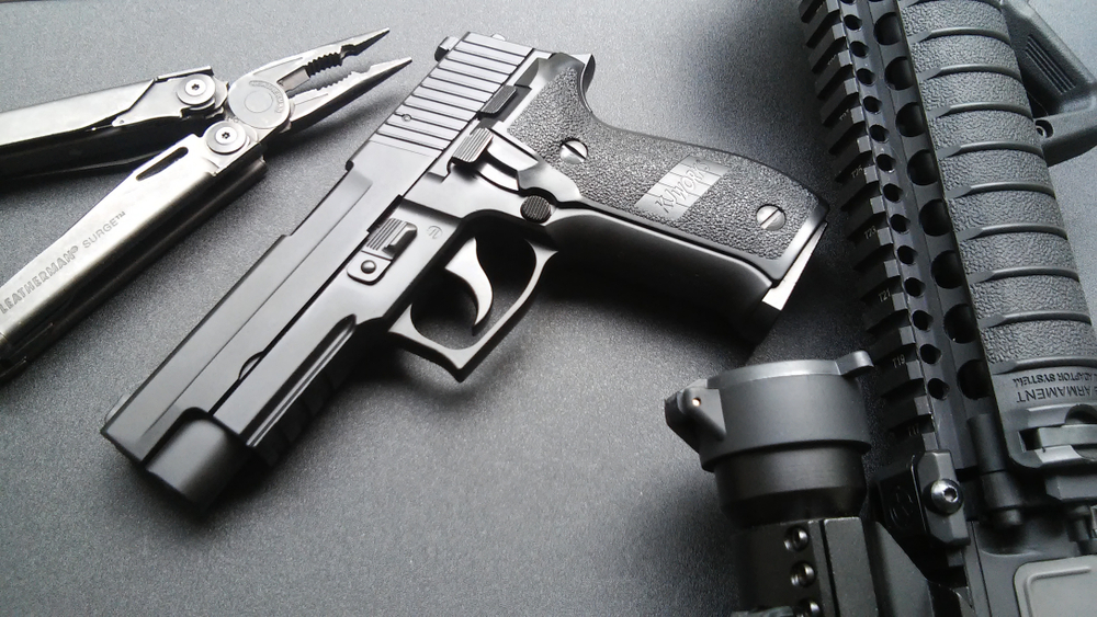 Sig P226 on table with other equipment